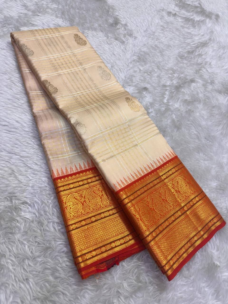 Ivory handwoven pure silk Kanjivaram saree with vermilion orange Zari Kattam border