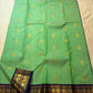 Deep navy korvai border with ornate gold zari peacock pallu panels on jade green saree — Idam Living