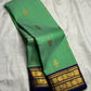 Handwoven jade green korvai Kanchipuram silk saree with mayil maanga butta and deep navy border — Idam Living