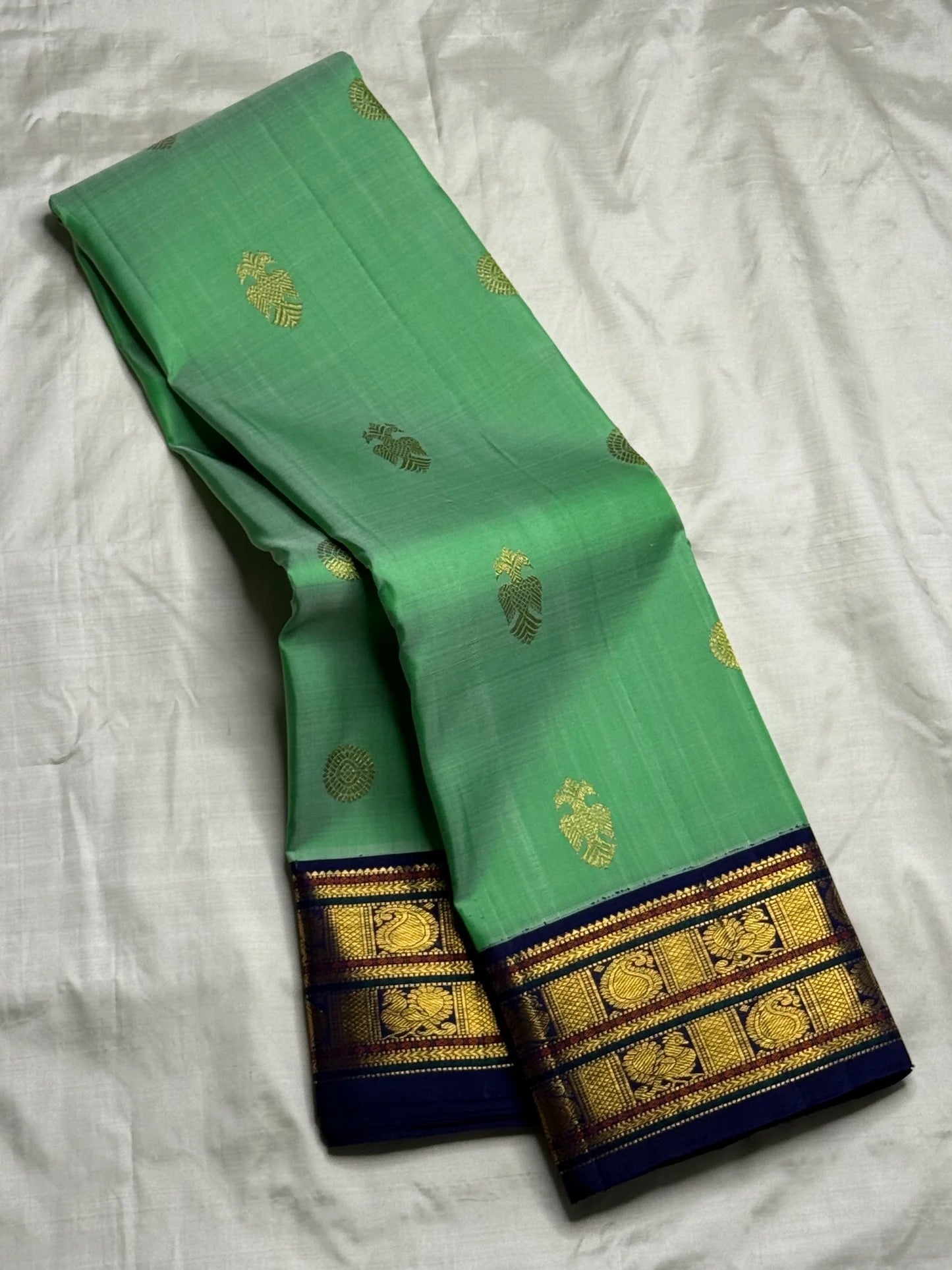 Handwoven jade green korvai Kanchipuram silk saree with mayil maanga butta and deep navy border — Idam Living