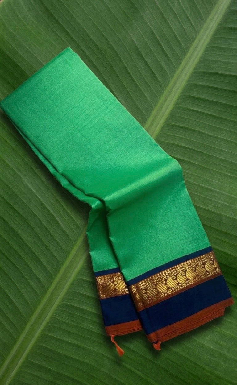 Kanchipuram silk saree in jade jewel green with navy blue border Korvai weave folded view
