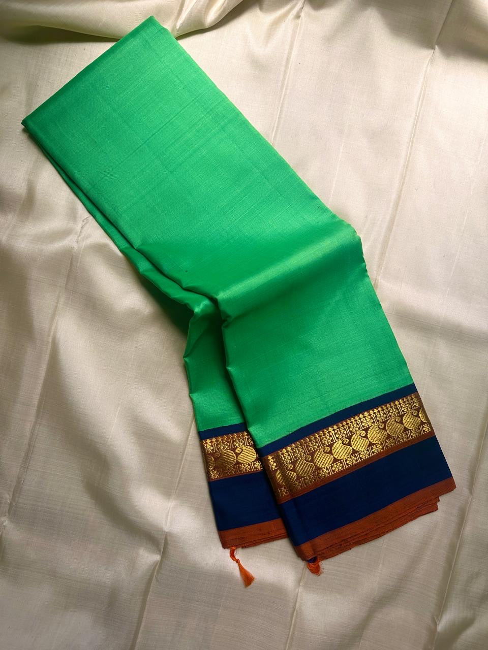 Kanchipattu silk saree in jade jewel green with navy blue border Korvai weave traditional zari detail