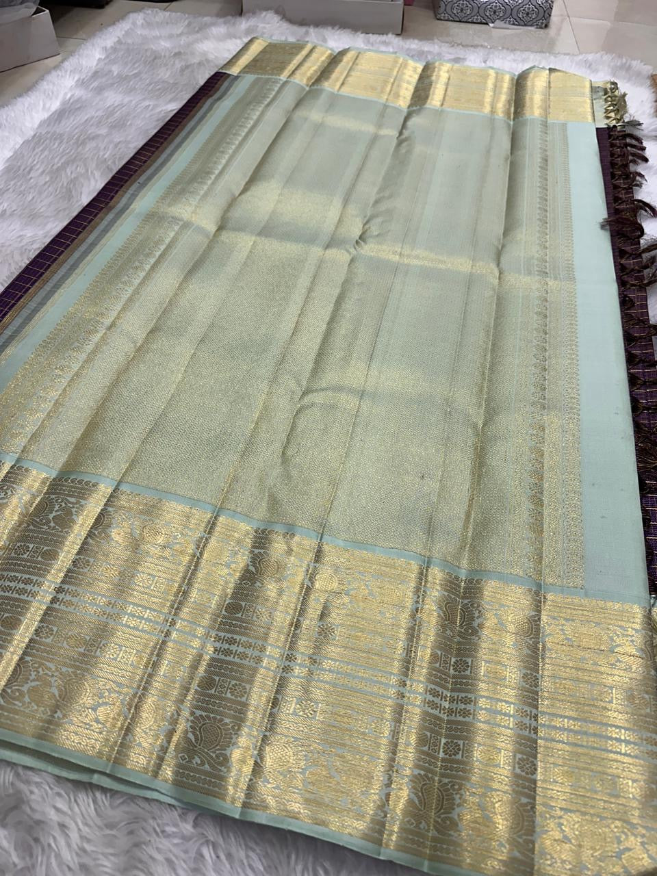 Jamun Plum Kanchipuram silk contrasted with Lotus-Mist Green and softly luminous classic gold zari.