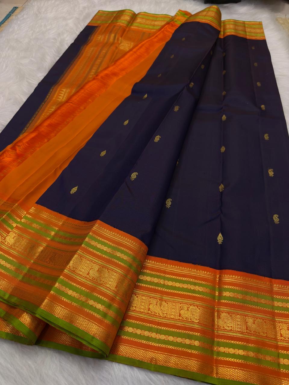 Orange and olive-green Korvai border detail, Naval Pazham purple KanchiPattu saree