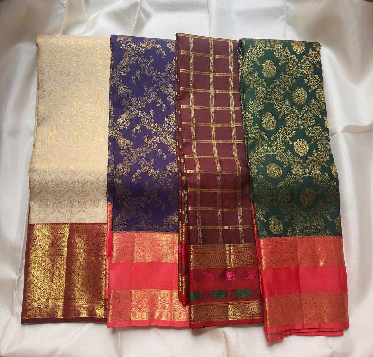 Jamun-violet Pure Silk Kanchipuram contrasted with Bougainvillea Pink and warm classic-gold zari registers.