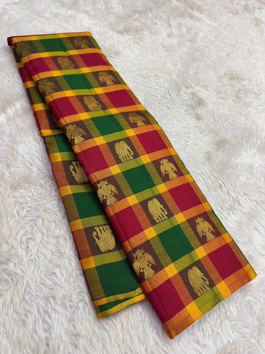 Pure Kanjivaram silk saree with emerald green and berry plum checks on banana leaf background