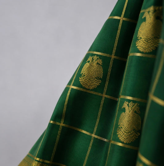 Luxury parrot green Kancheepuram pure silk saree with traditional zari border and intricate Gandaberunda motif weaving