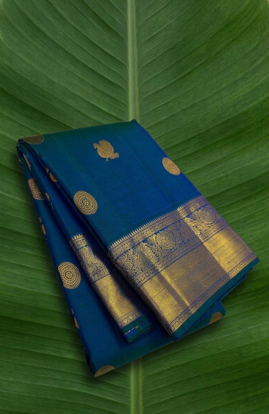 Luxury peacock blue Kancheepuram pure silk saree with circular Mayil Chakram butta design and classic zari accents