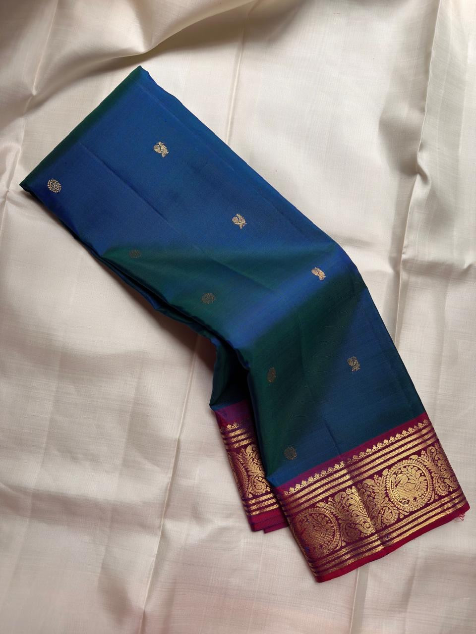 Handwoven Deep Kadal Neelam Blue Pure Silk Kanchipuram with a clean scattered Butta body.