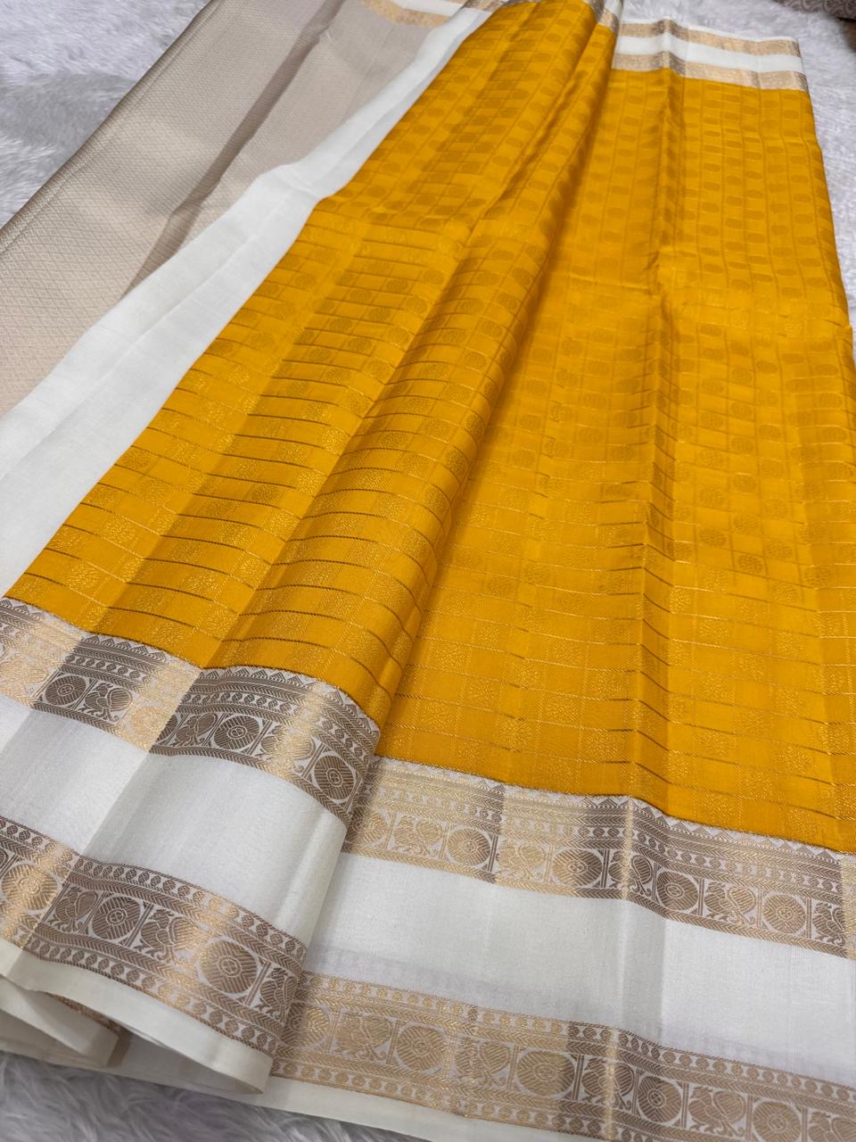 Kamalam lotus butta motif close-up, marigold Kanjivaram saree