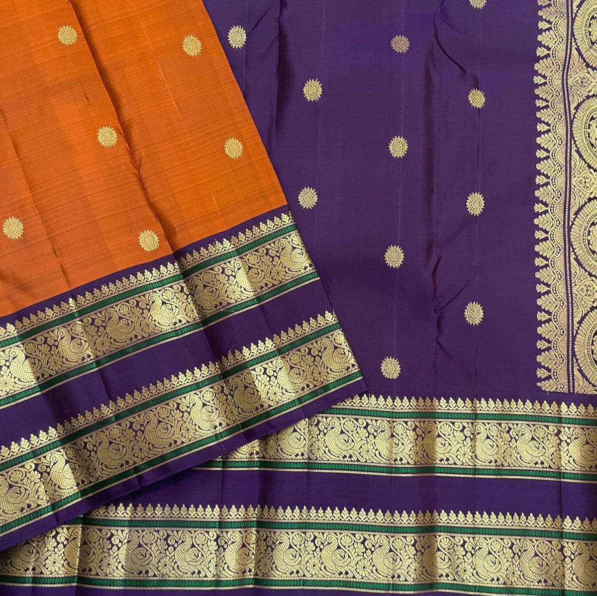 Kanakambaram orange pure silk Kanchipuram saree with spaced chakra-pushpam zari buttas and a Kathiripoo border.