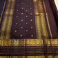 Close view of luminous gold zari buttas across Deep Kanchana Brown pure mulberry silk.