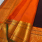 Close view of gold zari Mayil buttas woven across deep brown Kanchipuram silk.