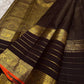 Dark brown Kanchipuram silk saree with fine gold checks and spaced zari motifs.