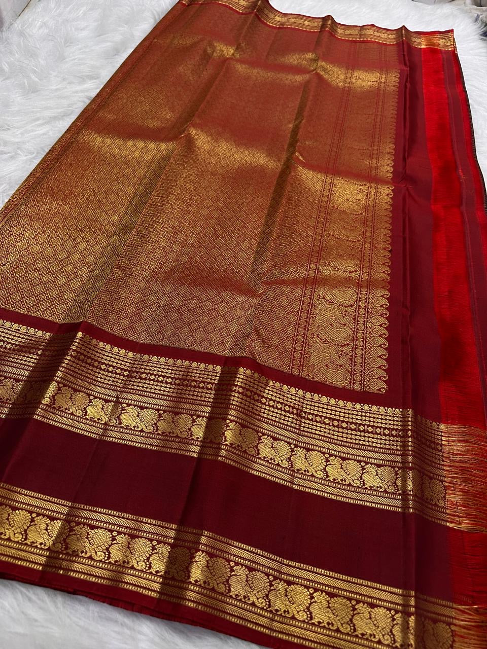 Arakku Red Kanchipuram border with traditional antique-gold Mayil motifs.