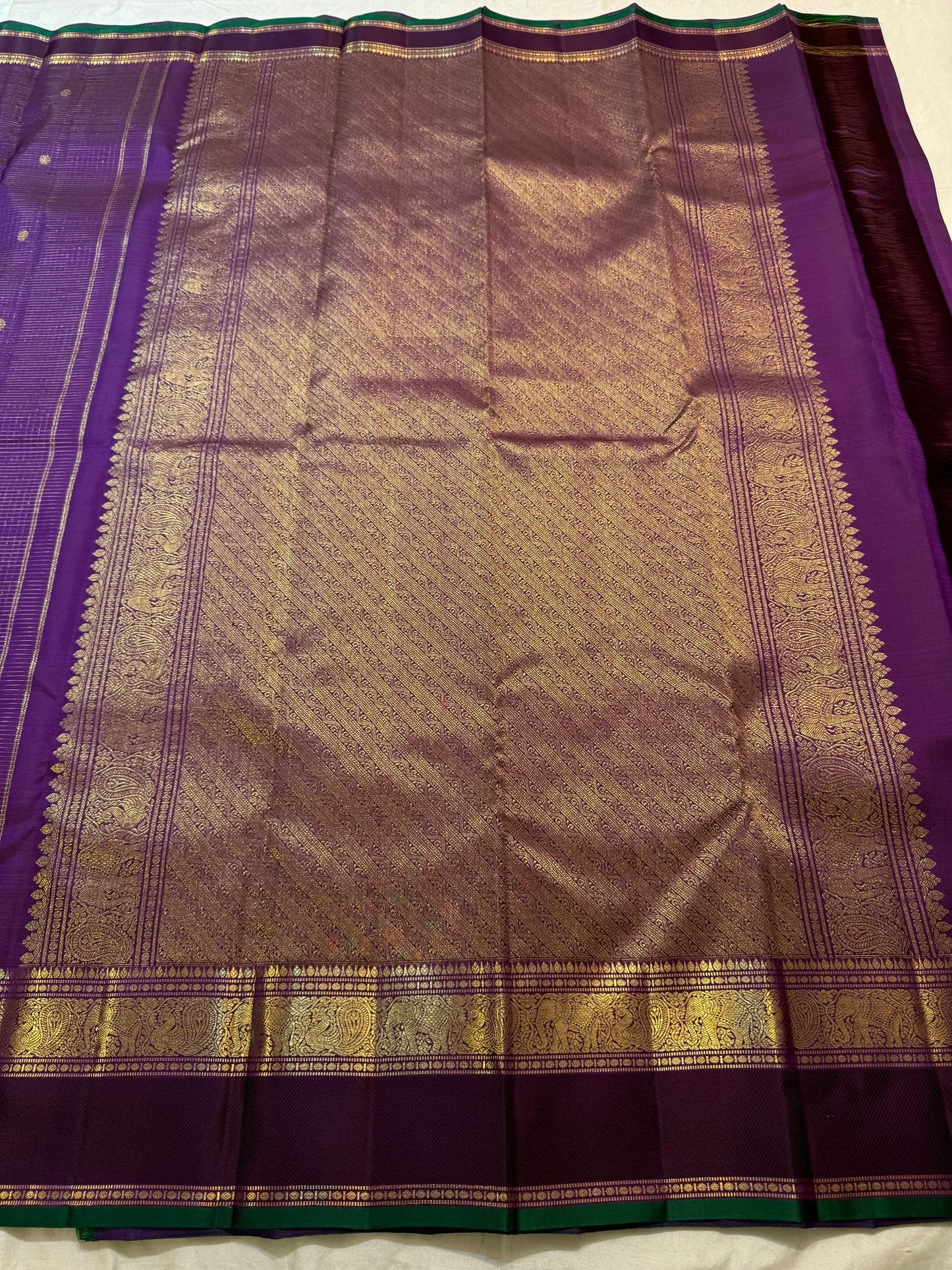 Close view of fine gold zari checks woven across deep Kanchana Purple pure silk.