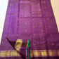 Folded Kanchana Purple Zari Kattam saree showing ornamental gold zari border.