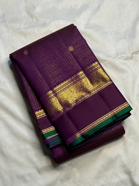 Deep purple Kanchipuram silk with fine intersecting gold Zari Kattam checks and spaced zari buttas.
