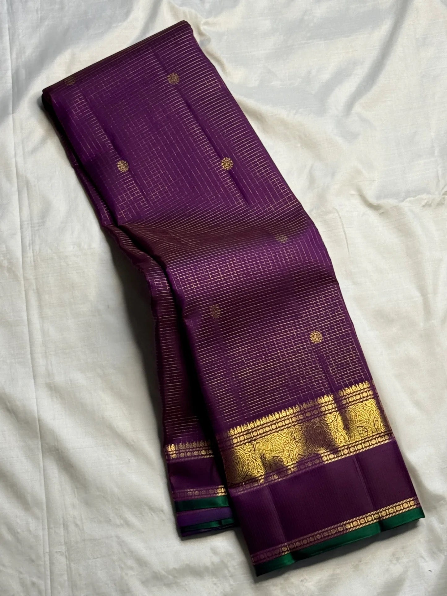 Kanchana Purple pure silk Kanchi Pattu Zari Kattam saree with gold zari border and green edge.