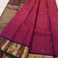 Broad aubergine-purple border with antique-gold peacock and malar kodi vine zari and forest-green edge on raspberry red Kanchipuram silk saree