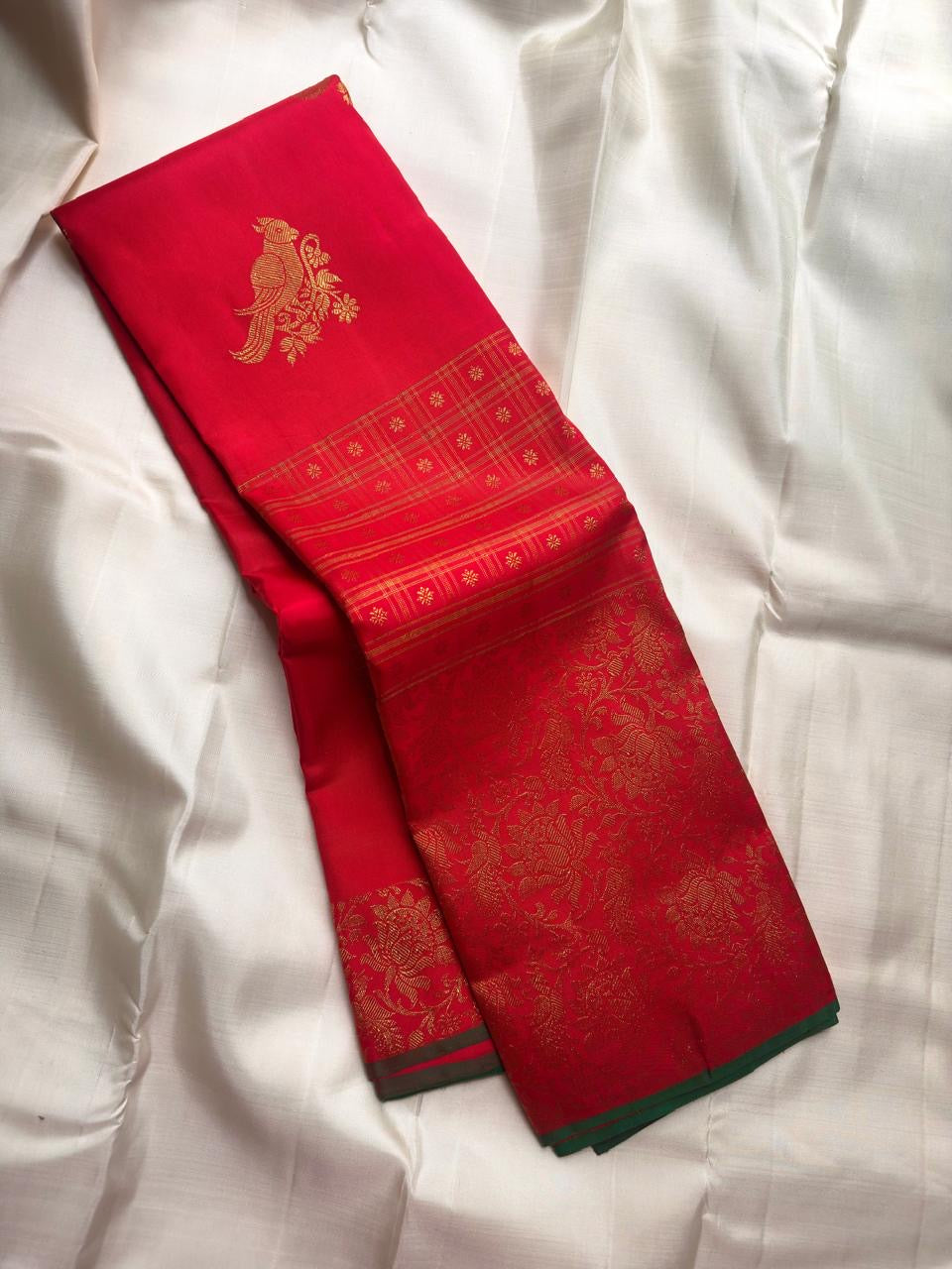 Fine gold zari checks with delicate Nakshatram star motifs above the richly patterned Kanchipuram border.