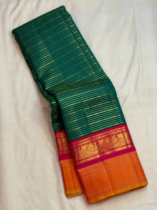 Peacock teal Korvai pure silk Kanchipuram saree with thick Veldhari body, double Korvai border and sunset-orange grid pallu, Idam Living (photo 1 of 5)