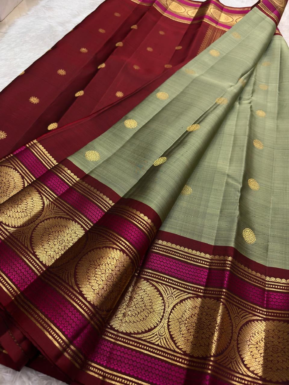 sage green Kanchipuram silk saree with kb weave folded view