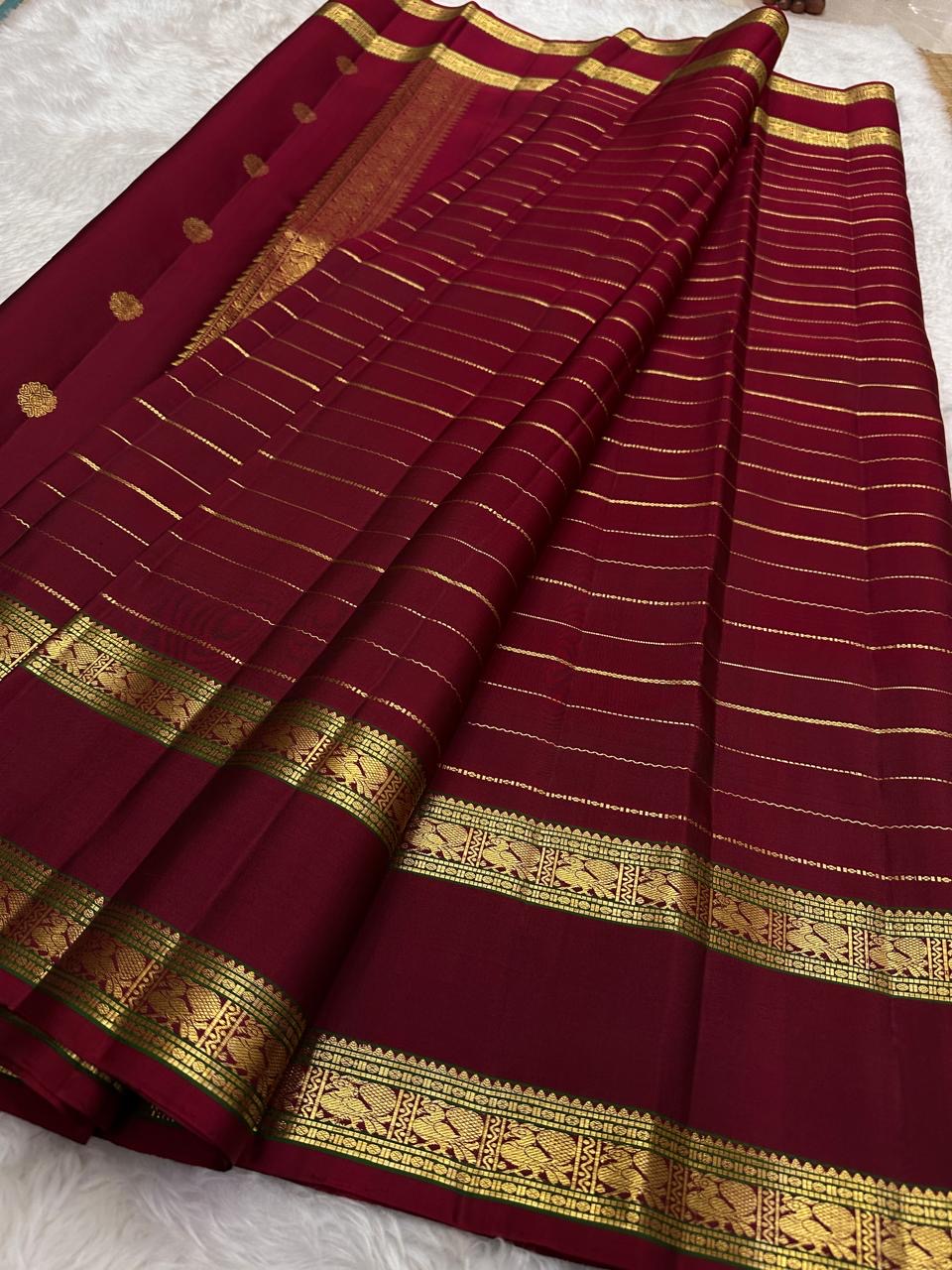 leaf green border detail of deep red Kanchipuram silk saree