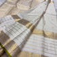 Ivory pure silk Kanchipuram saree, silk texture close up with pearl ivory, pale gold and thulir-pachai fresh-green selvedge