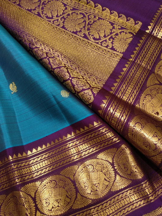 Blue Kanchipuram silk saree with Mayil butta motifs and antique gold border folded view