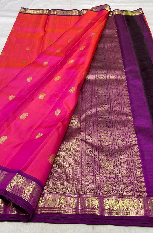 Coral pink Kanchipuram silk saree with purple korvai border folded view