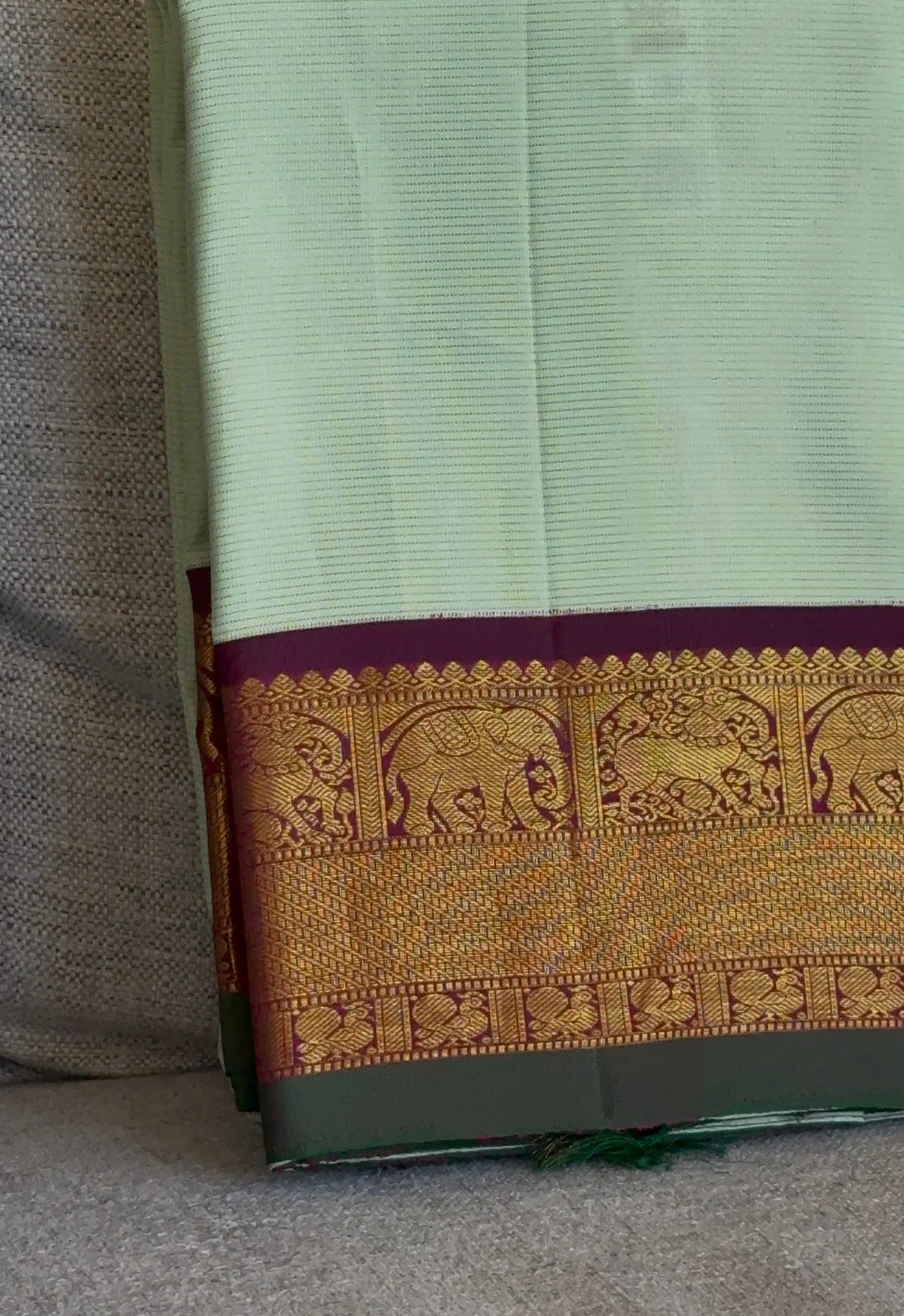 Pure Kanjeevaram pastel silk saree flat lay showing refined vairaoosi zari detailing