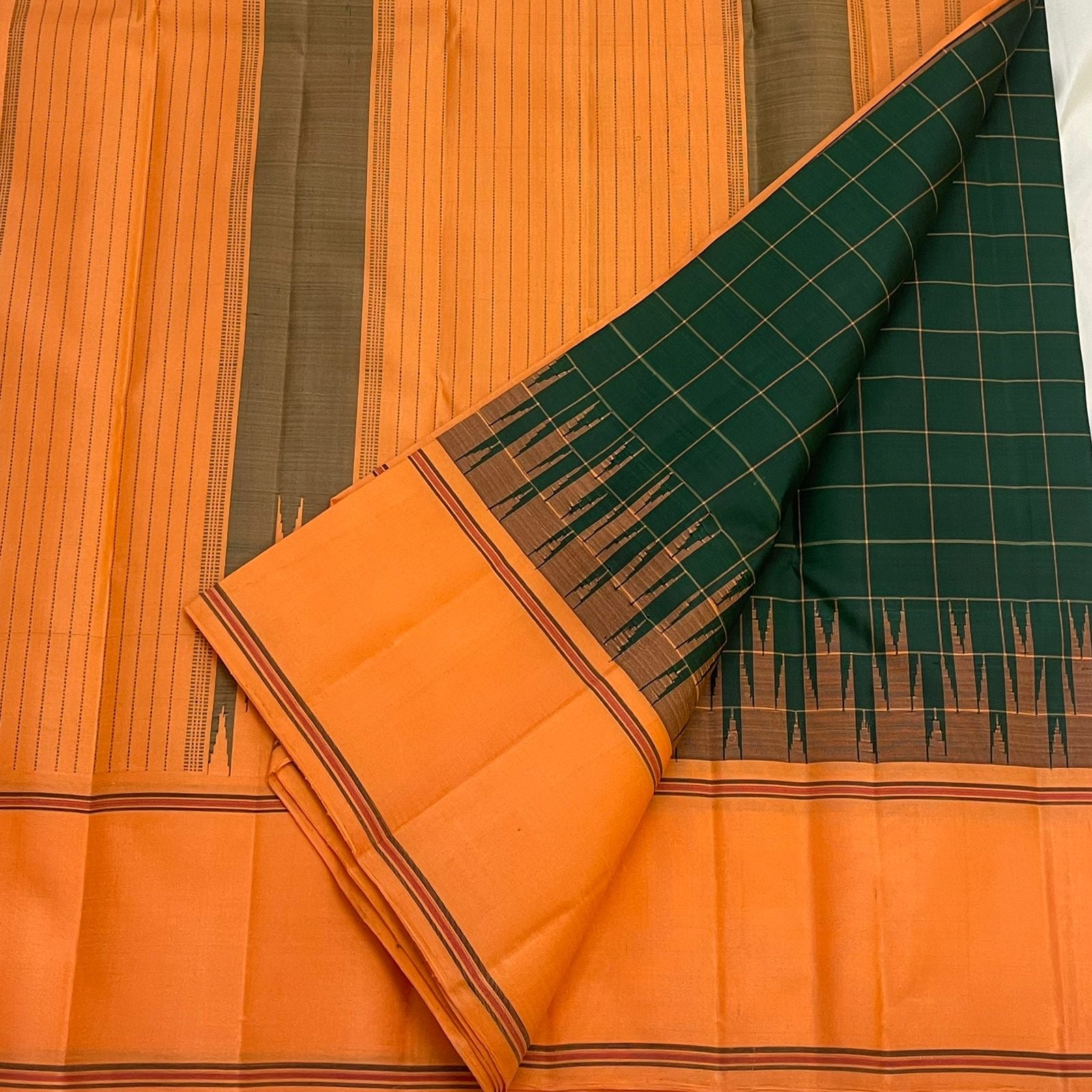 Forest green Kanjipuram silk saree Kanchi Kattam body close-up showing fine gold zari checkered grid texture