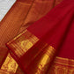 Vermilion red, warm Arakku-red undertones and rich yellow gold handwoven Kanchipuram butta silk saree, border zari detail, with gold zari detailing.