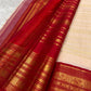 Warm ivory Vairaoosi pure silk Kanchipuram saree – Arakku red border with stacked zari ornament and peacock figures