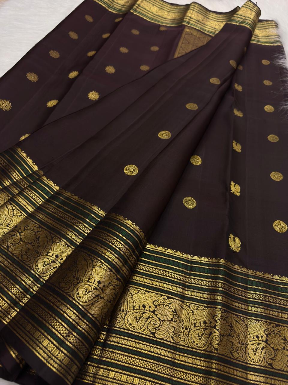 Coffee brown pure silk Kanchipuram saree with antique gold mayil chakram buttas, deep green accents, and a detailed peacock and arai maadam pallu, view 6.