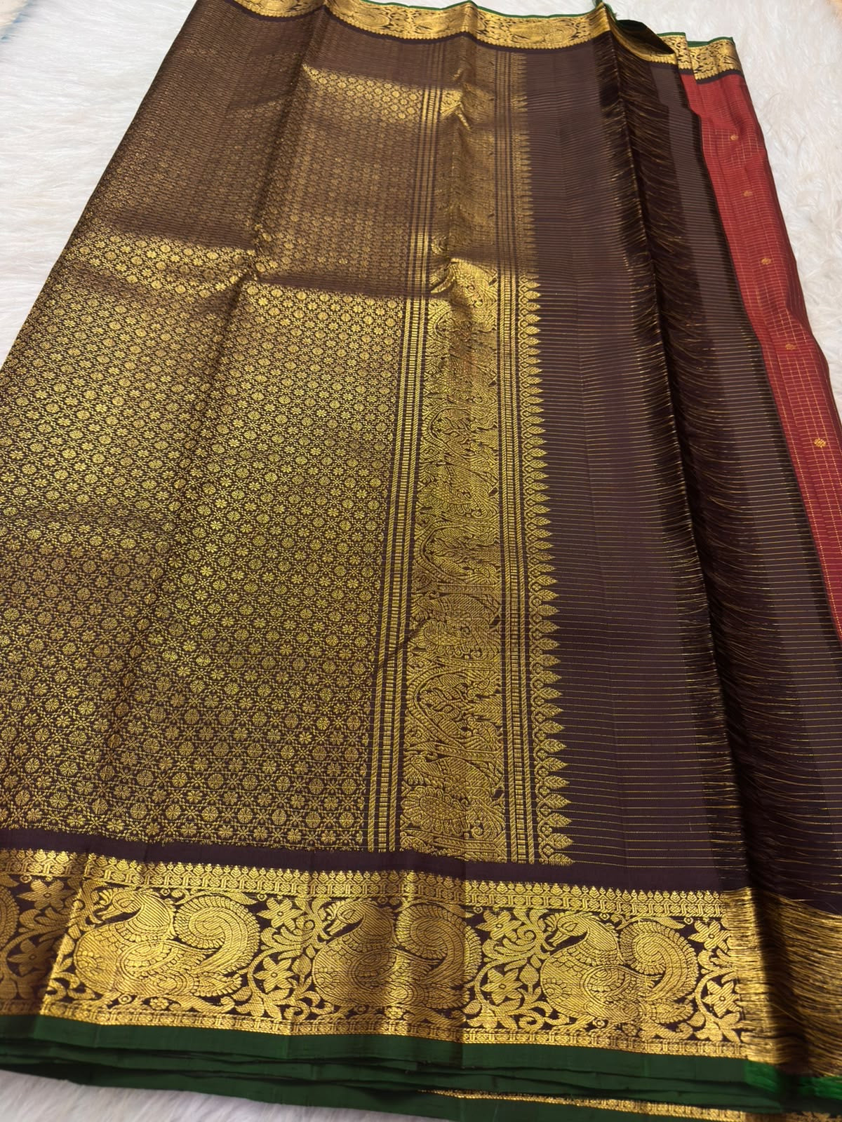Close view of gold zari kattam checks and tiny buttas on vermilion red pure silk Kanchipuram saree body