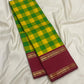 Manjal yellow and ilai pachai kattam checks woven in pure silk on a Kanchipuram Kanchi Kattam saree
