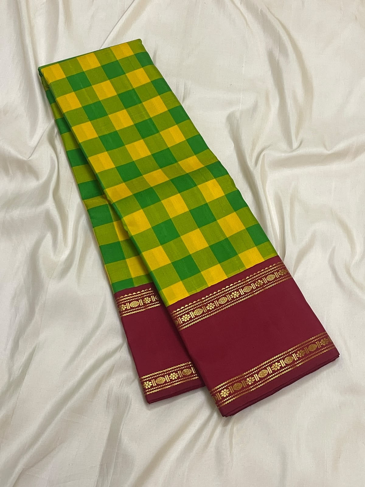 Manjal yellow and ilai pachai kattam checks woven in pure silk on a Kanchipuram Kanchi Kattam saree