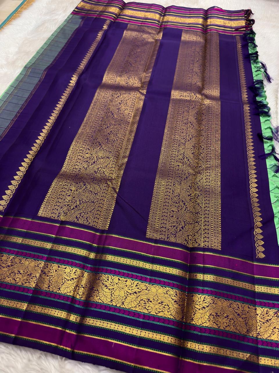 Kanchi silk saree aqua body with fine checkered weave and rich plum contrast border draped fold view