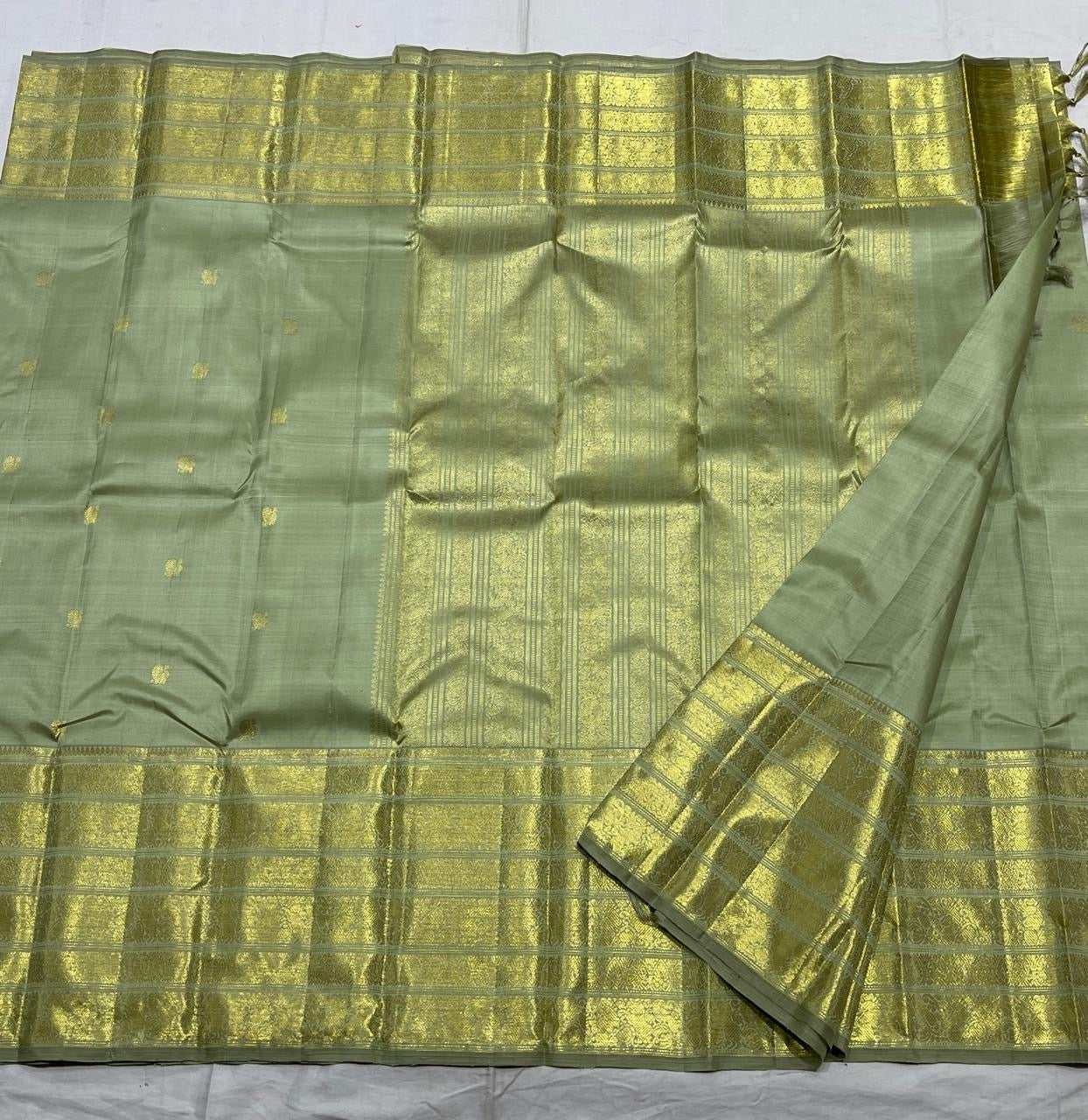Sage green handwoven pure silk Kanchipuram Varisaipet saree — close view of the body weave and texture