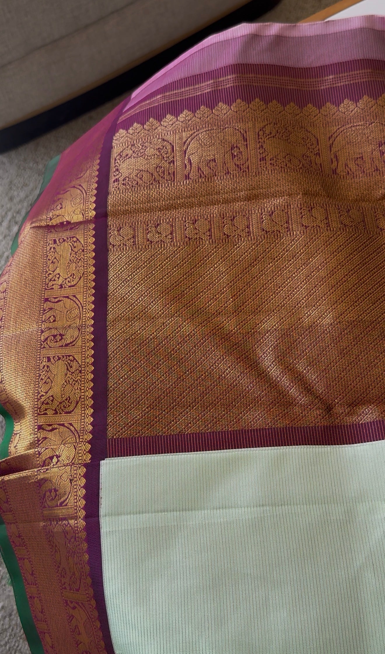 Light pastel Kanjivaram silk saree texture closeup highlighting shifting sheen of vairaoosi weave