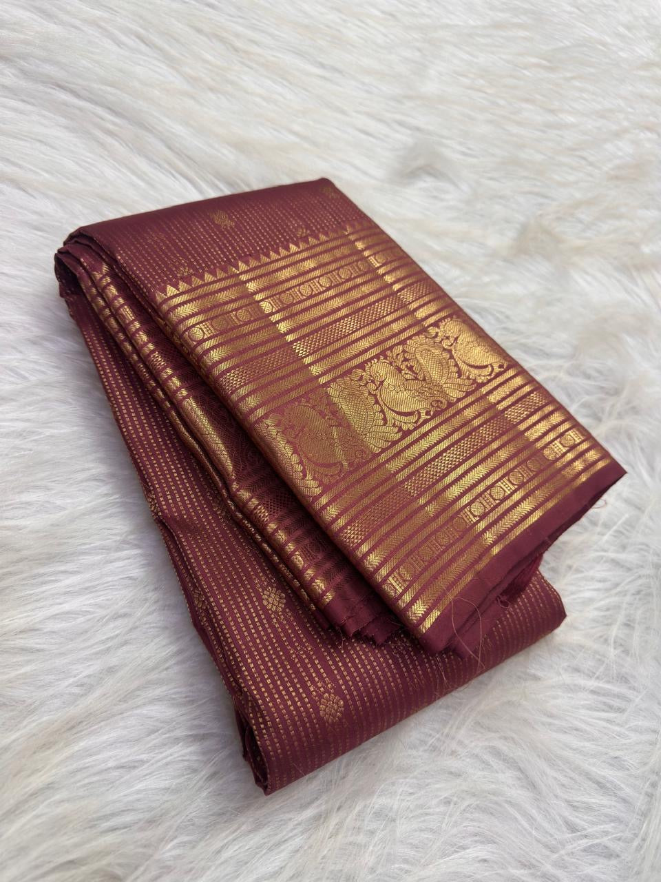 Traditional Annam sacred-bird motifs in antique-gold zari panels on Earthy Rose Kanchipuram silk