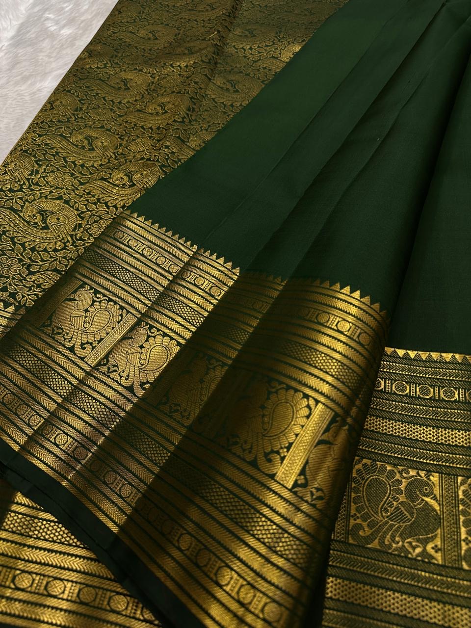 Deep Green Kanchipuram Butta saree with antique-gold sacred bird border