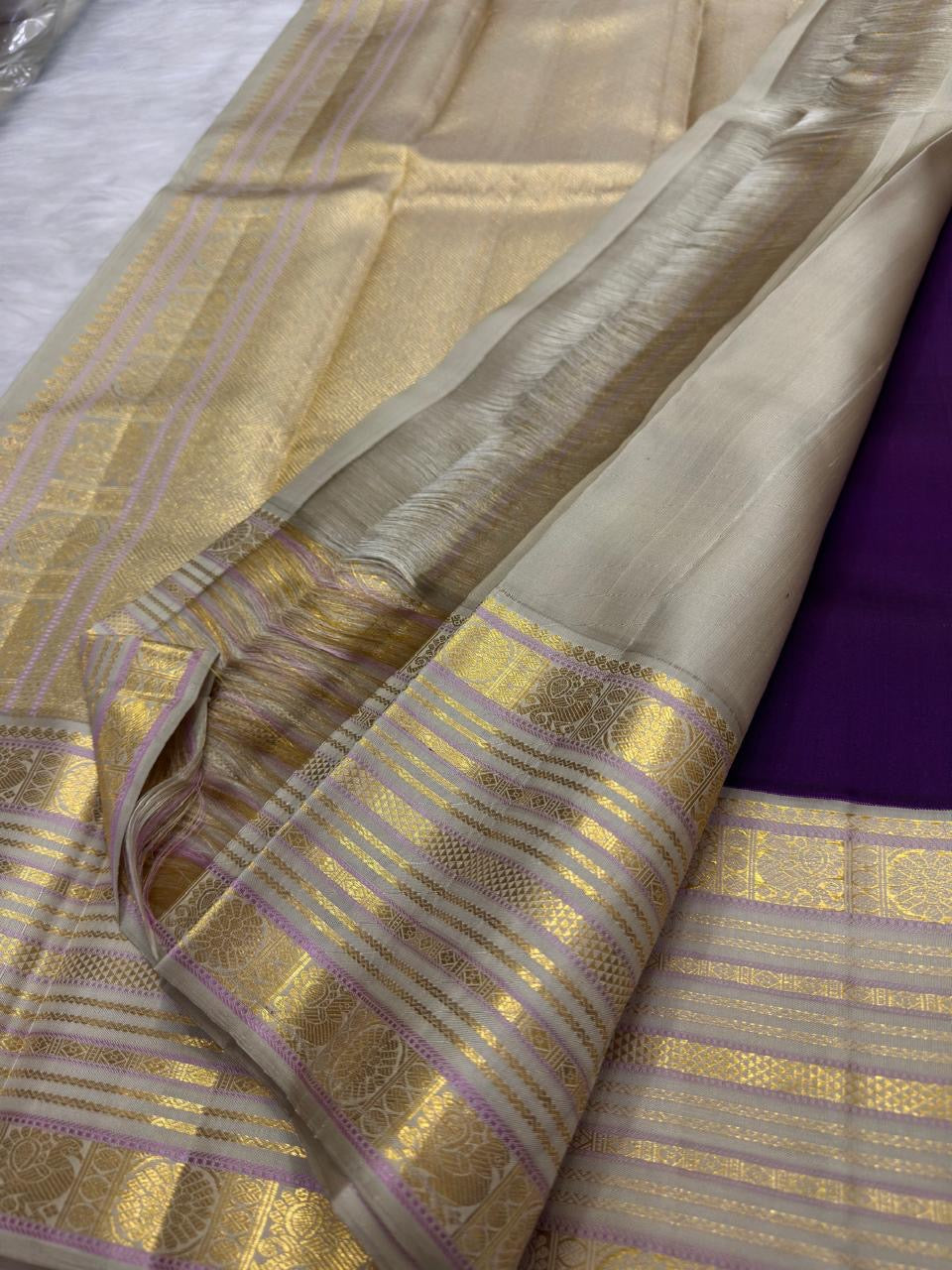 Deep Kathiripoo purple Kanchipuram saree with sandalwood gold border and zari pallu.