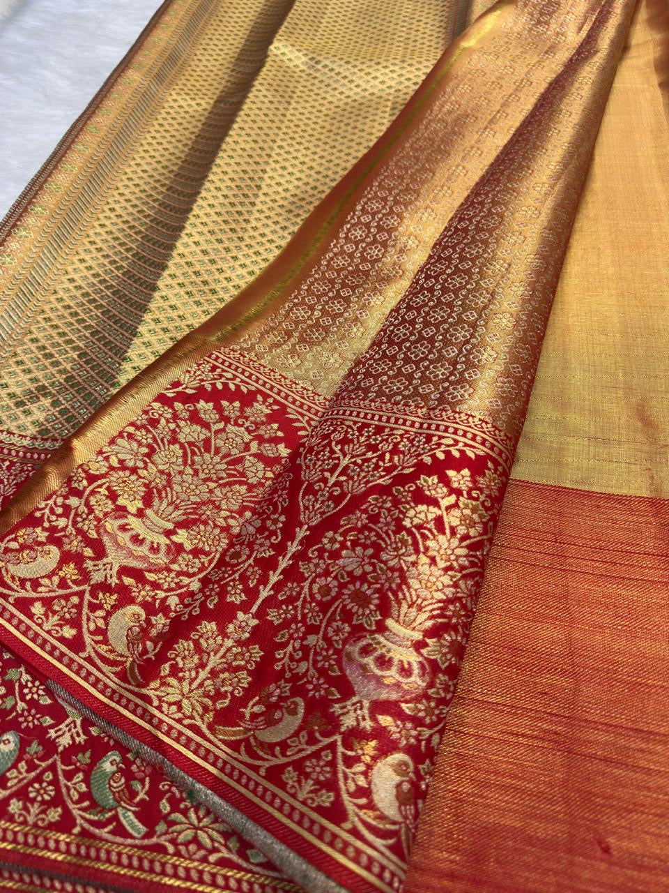 Sandalwood ivory handwoven pure silk Banarasi-Kanchipuram fusion saree with champagne-gold zari and vermilion-red floral urn and bird border