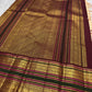 Soft peach ivory Kanchi Pattu saree with maroon geometric zari pallu.