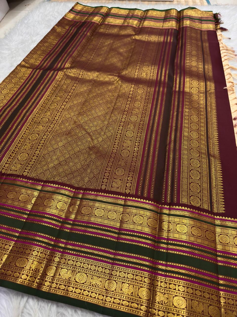 Soft peach ivory Kanchi Pattu saree with maroon geometric zari pallu.