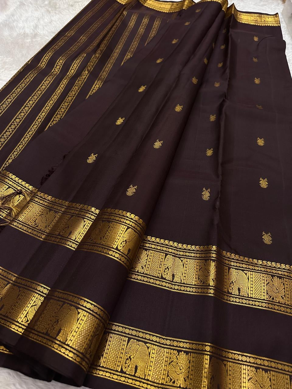 Deep plum Kanchipuram silk saree with scattered gold zari buttas