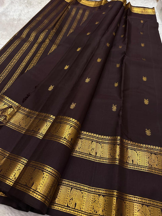 Deep plum Kanchipuram silk saree with scattered gold zari buttas